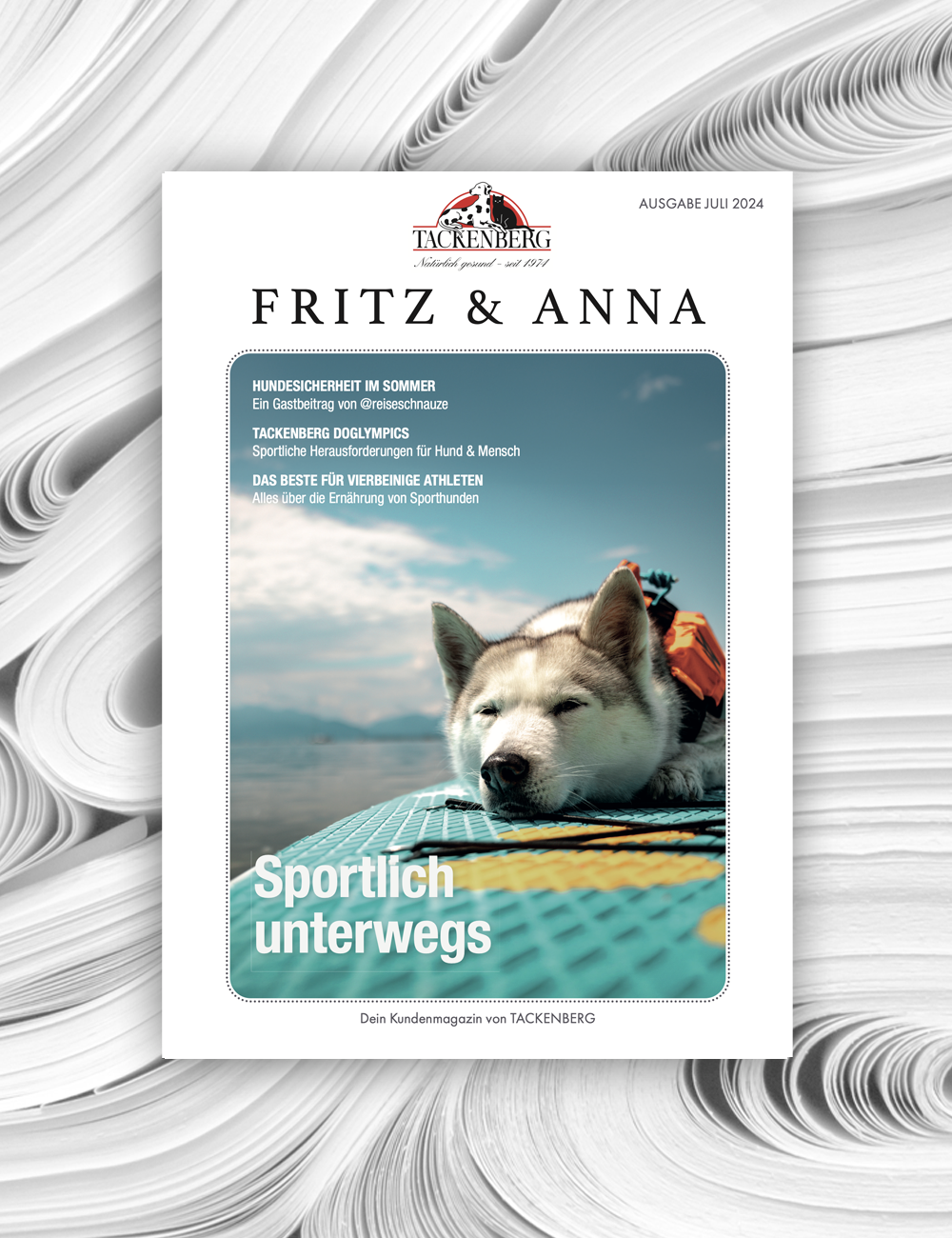 Ein Kundnemagazin, Fritz und Anna. Es sit eine Husky auf einem Surfbrett zu sehen, es ist Sommer.